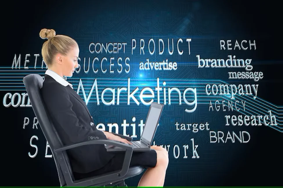 Businessperson using a laptop before a board of marketing concepts.