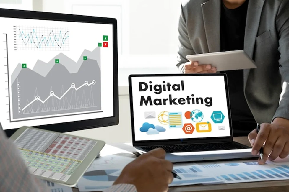 Businesspeople reviewing digital marketing graphics and performance charts.